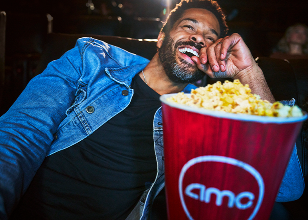 Man watching movie with AMC popcorn