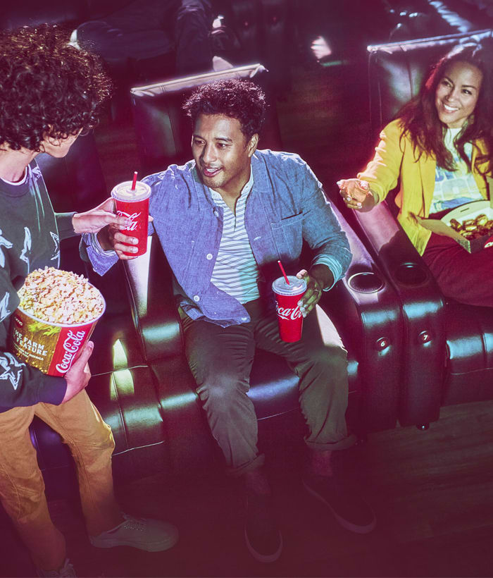 family eating concessions at a movie