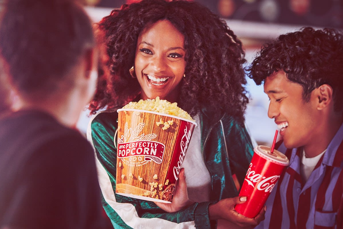 group of friends eating and having drinks at AMC