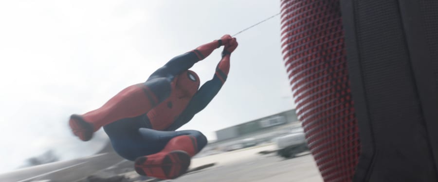 Spider-Man swings around Giant Man's leg