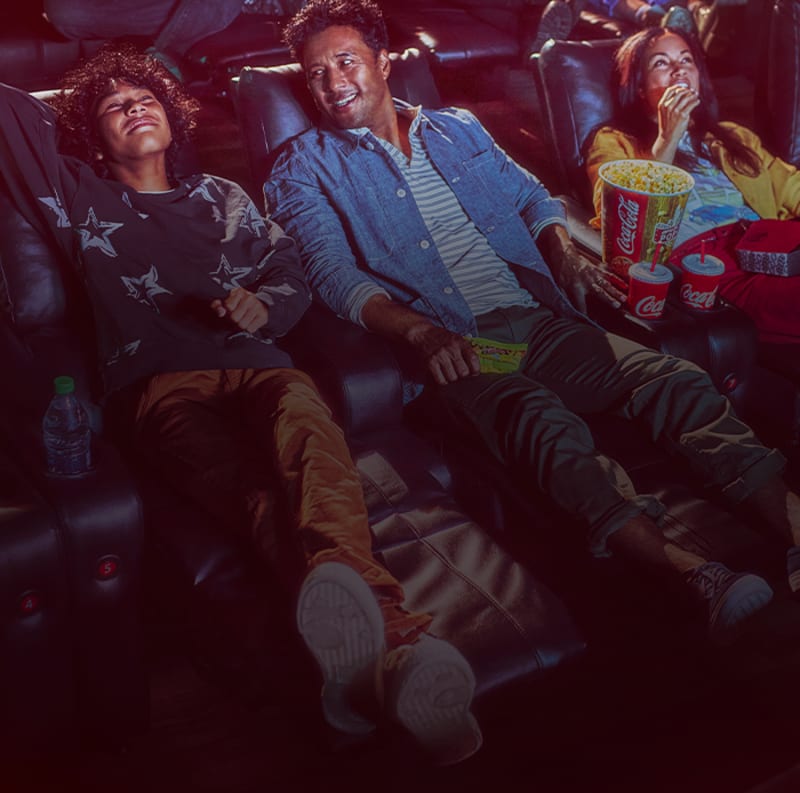 family watching a movie in theatre